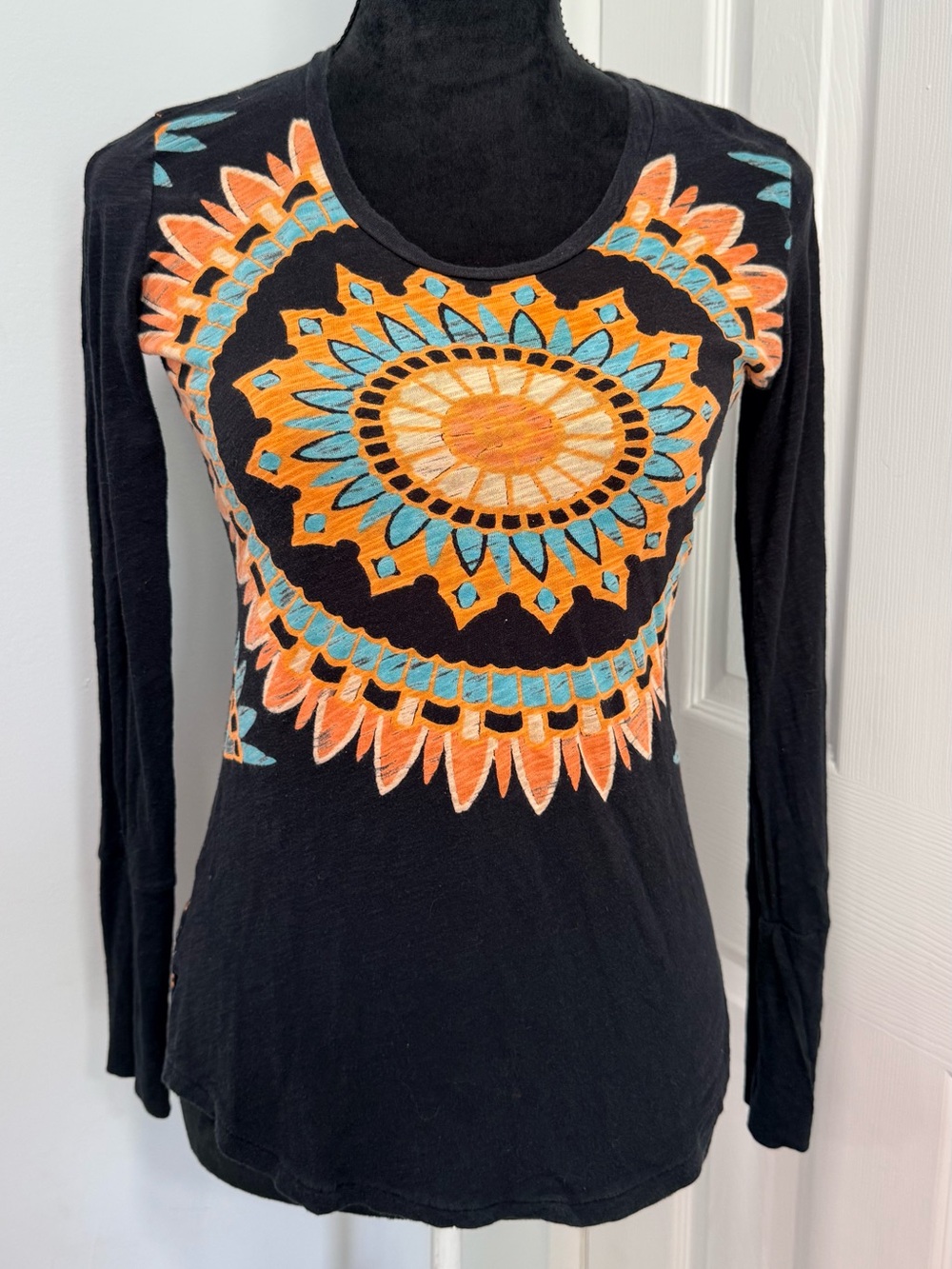 chic Black Long Sleeve Tee with Orange and Teal Sunburst Motif